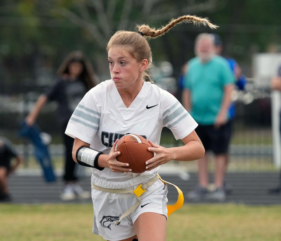 New Smyrna quarterback Emma Corr looks to run during a flag football game with Mainland at Mainland High School in Daytona Beach, Tuesday, March 28, 2023 
