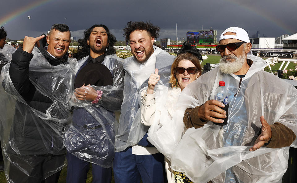 Racegoers, pictured here celebrating in the rain at the Melbourne Cup.