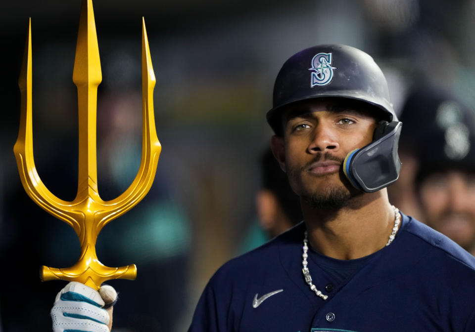 Seattle Mariners' Julio Rodriguez poses with a trident after hitting a two-run home run against the Milwaukee Brewers during the third inning of a baseball game Wednesday, April 19, 2023, in Seattle. (AP Photo/Lindsey Wasson)