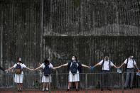 FILE PHOTO: Secondary school students hold hands as they form a human chain in Hong Kong