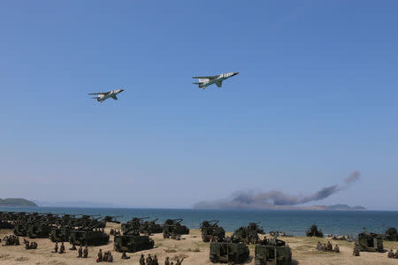 Jets perform a flyby after a live fire "target-striking contest" held by North Korean leader Kim Jong Un on August 26, 2017 just next to Kalma International Airport in Wonsan, North Korea. KCNA/via REUTERS