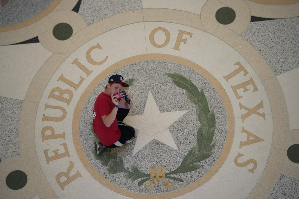 A visitor to the Texas Capitol takes photos in the rotunda, Thursday, July 8, 2021, in Austin, Texas. Texas Gov. Greg Abbott called a special session that began Thursday. (AP Photo/Eric Gay)