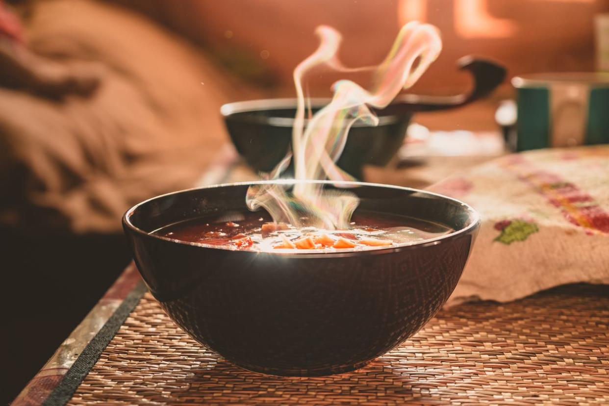 Hot vegetable soup in a dish made of natural materials