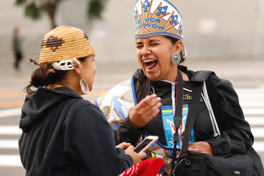 Katianna Warren, right, laughs with Miztlayolxochitl Aguilera