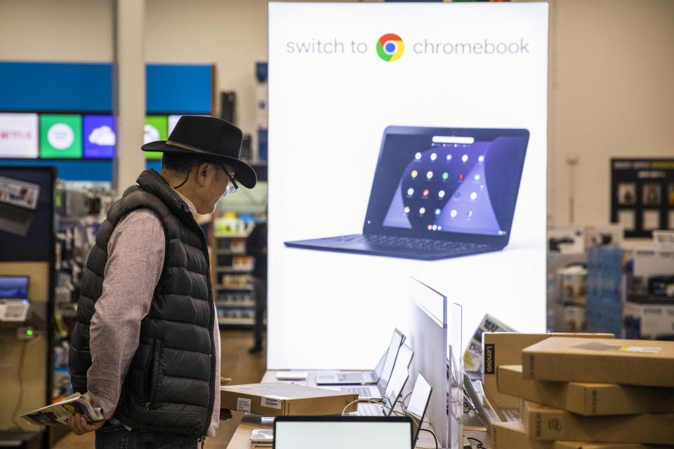 EMERYVILLE, CA - NOVEMBER 29: A Black Friday shopper looks at laptop computers at a Best Buy store on November 29, 2019 in Emeryville, United States. Black Friday is traditionally the biggest shopping event of the year, and marks the beginning of the holiday shopping season. (Photo by Philip Pacheco/Getty Images)