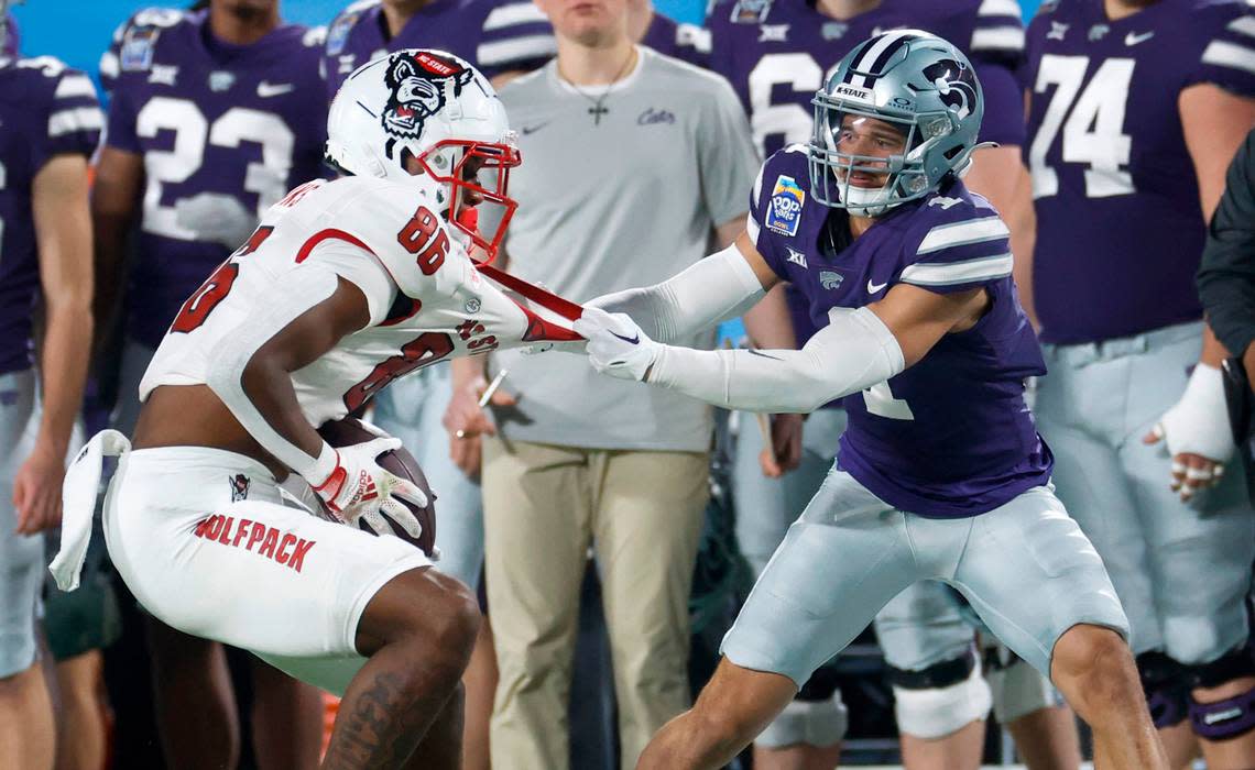 Kansas State cornerback Keenan Garber (1) tackles N.C. State wide receiver Dacari Collins (86) after Collins made a reception during the second half of Kansas State’s 28-19 victory over N.C. State in the Pop-Tarts Bowl at Camping World Stadium in Orlando, Fla., Thursday, Dec. 28, 2023. Ethan Hyman/ehyman@newsobserver.com