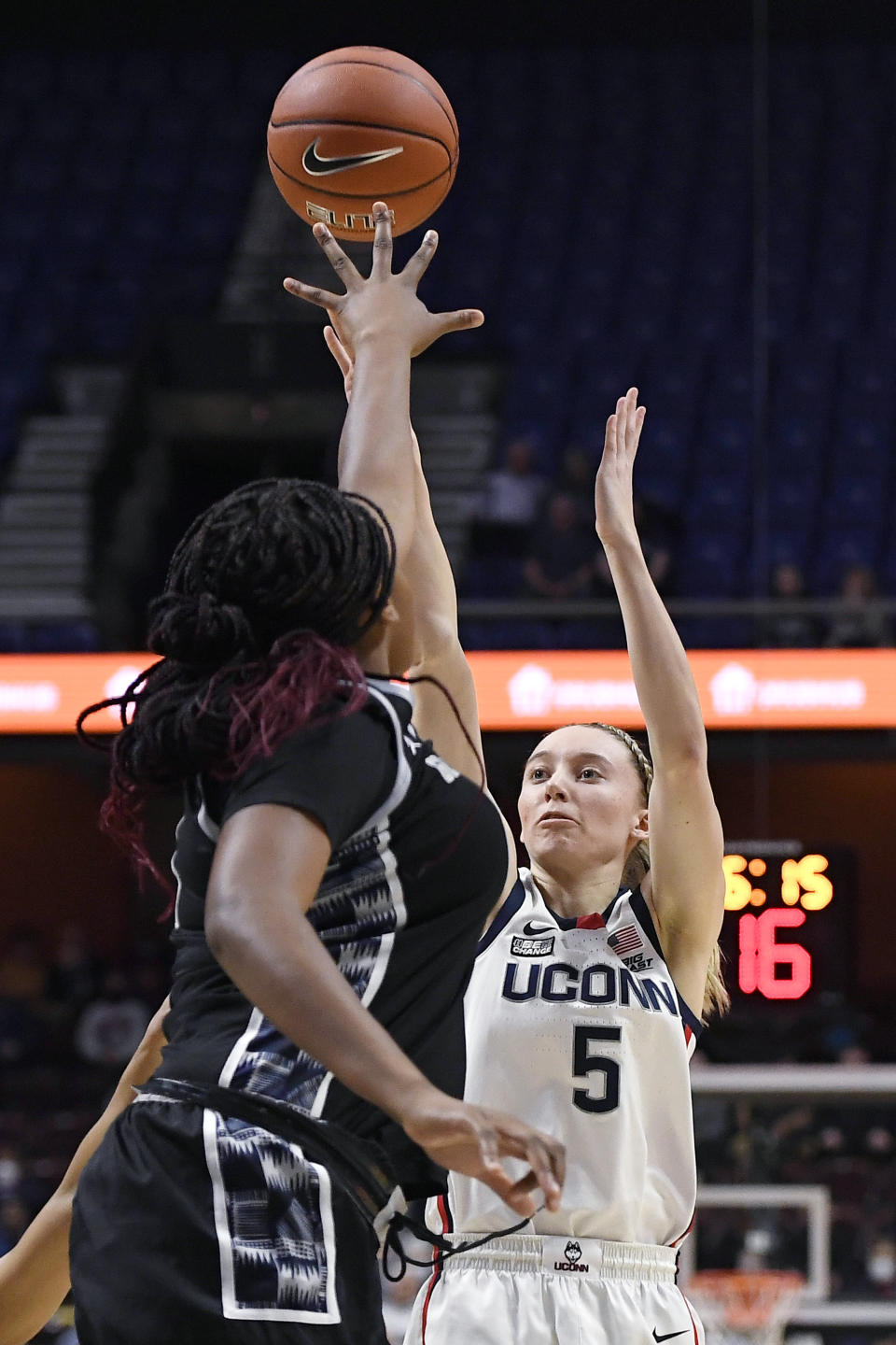 Connecticut's Paige Bueckers, right, shoots over Georgetown's Ariel Jenkins during the first half of an NCAA college basketball game in the quarterfinals of the Big East Conference tournament at Mohegan Sun Arena, Saturday, March 5, 2022, in Uncasville, Conn. (AP Photo/Jessica Hill)