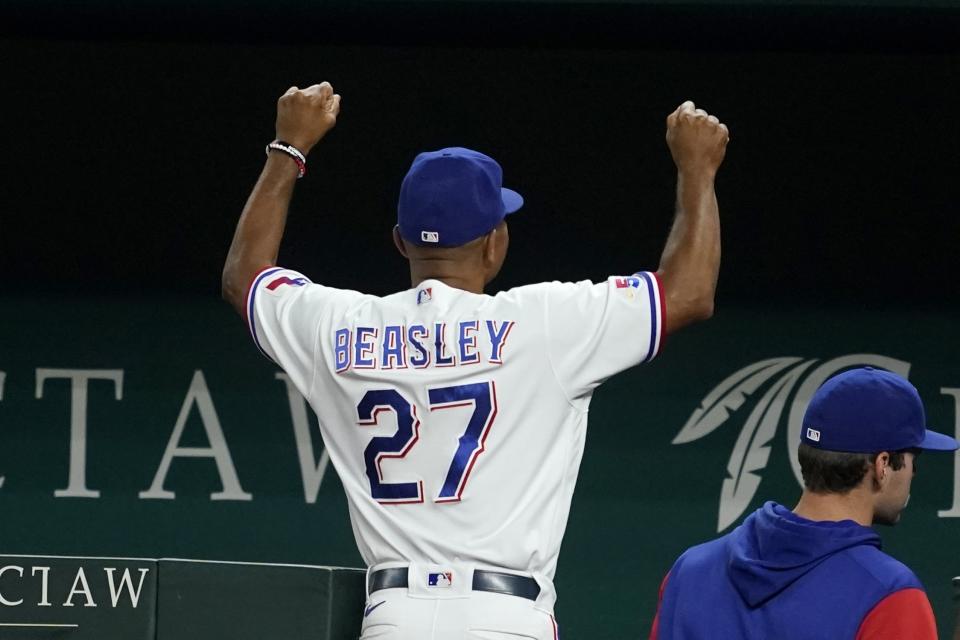 Texas Rangers interim manager Tony Beasley gestures to fans as he walks off he field, celebrating the team's 2-1 win in a baseball game against the Oakland Athletics in Arlington, Texas, Monday, Aug. 15, 2022. (AP Photo/Tony Gutierrez)