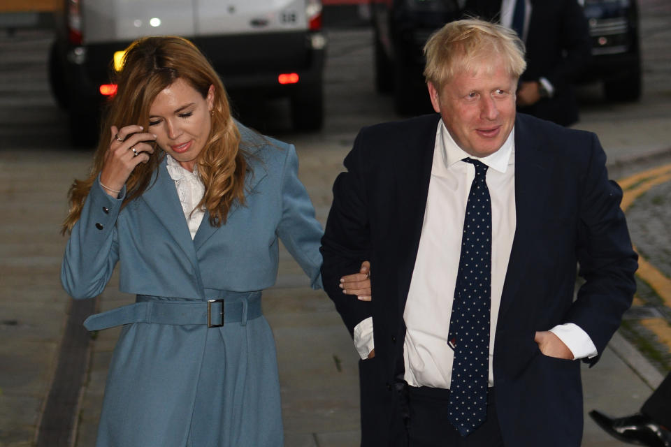 Britain's Prime Minister Boris Johnson walks with his partner Carrie Symonds as they arrive at The Midland, near the Manchester Central convention complex in Manchester, northwest England on September 28, 2019, on the eve of the annual Conservative Party conference. - Embattled British Prime Minister Boris Johnson gathers his Conservative party Sunday for what could be its final conference before an election, and is set to be dominated by fighting talk on Brexit. (Photo by Oli SCARFF / AFP)        (Photo credit should read OLI SCARFF/AFP/Getty Images)