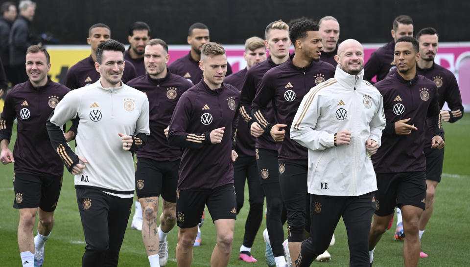 Germany national team players run a lap during the national team's training session at the DFB campus prior to the international match between Germany and Peru, in Frankfurt, Germany, Wednesday March 22, 2023. (Arne Dedert/dpa via AP)