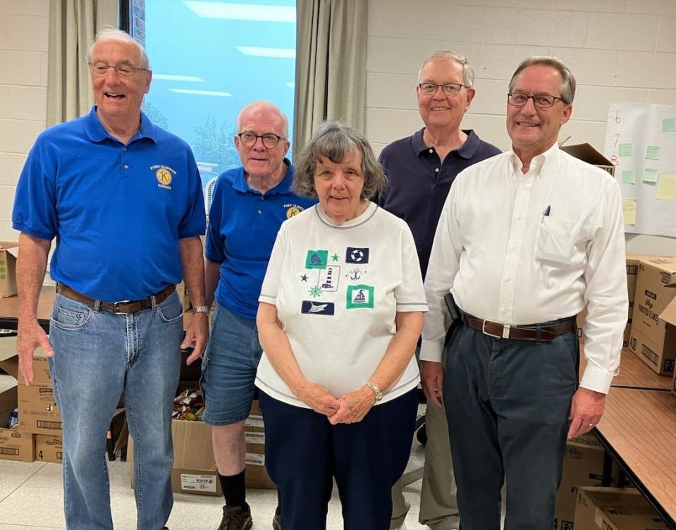 Members of the Port Clinton Kiwanis Club help to pack lunches for children in Ottawa County recently.
