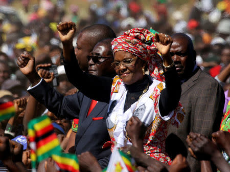 FILE PHOTO: President Robert Mugabe and his wife Grace greet supporters of his ZANU (PF) party during a rally in Harare, Zimbabwe, May 25, 2016. REUTERS/Philimon Bulawayo/File Photo