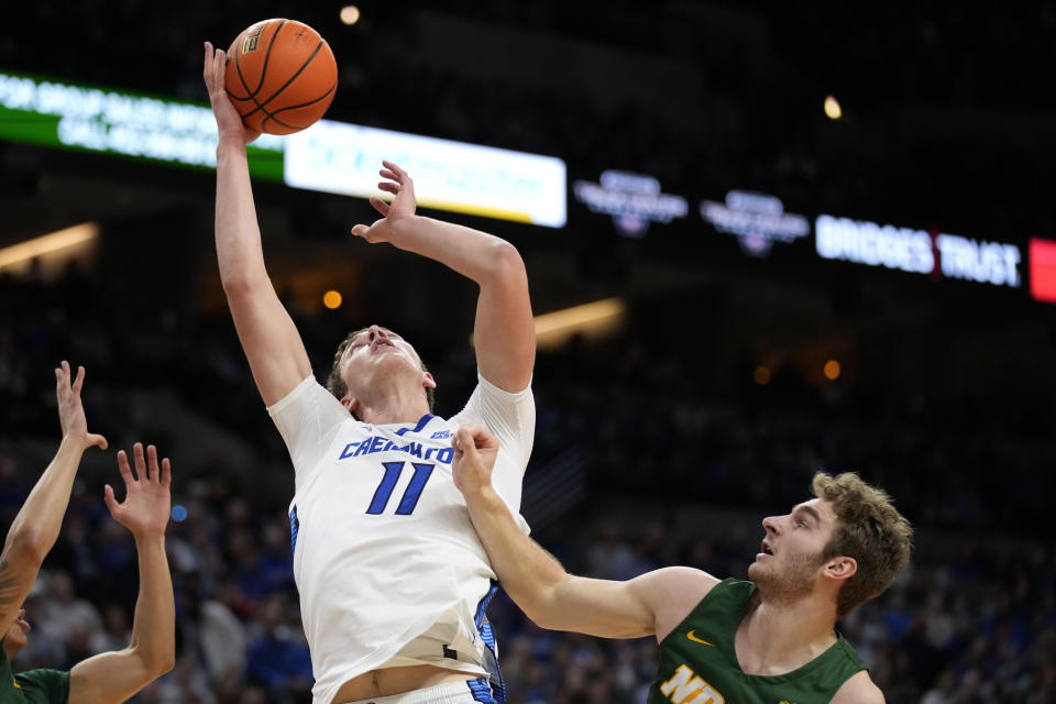 Creighton center Ryan Kalkbrenner (11) grabs a rebound over North Dakota State forward Joshua Streit, right, during the second half of an NCAA college basketball game, Saturday, Nov. 11, 2023, in Omaha, Neb. Creighton won 89-60. (AP Photo/Charlie Neibergall)