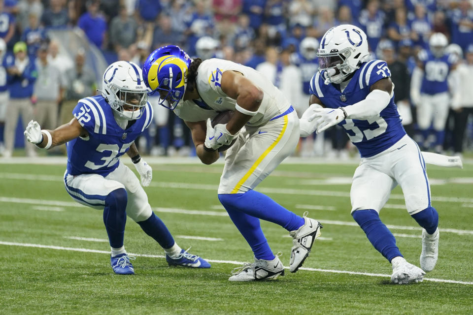 Los Angeles Rams wide receiver Puka Nacua, center, makes a catch as Indianapolis Colts safety Julian Blackmon, left, and cornerback Dallis Flowers defend during the first half of an NFL football game, Sunday, Oct. 1, 2023, in Indianapolis. (AP Photo/Michael Conroy)