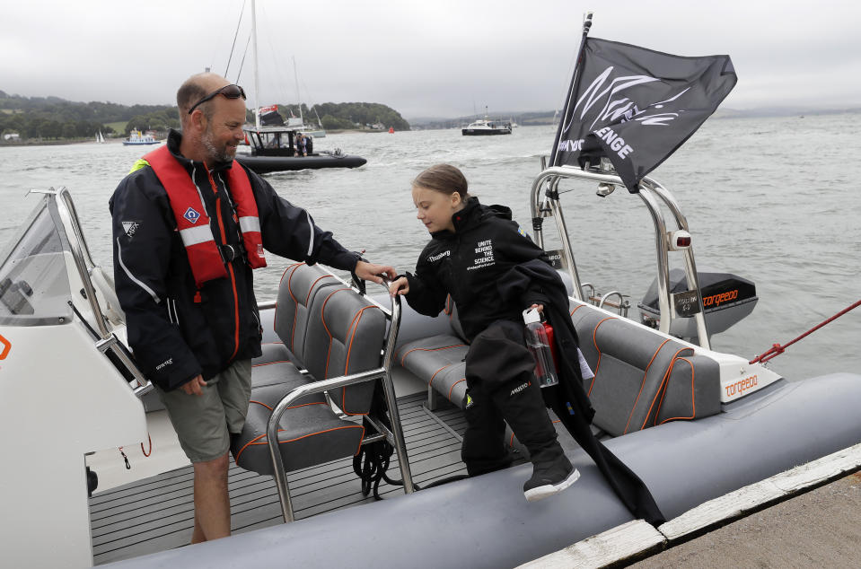 Climate change activist Greta Thunberg enters a dinghy to board the Malizia II boat in Plymouth, England, Wednesday, Aug. 14, 2019. The 16-year-old climate change activist who has inspired student protests around the world will leave Plymouth, England, bound for New York in a high-tech but low-comfort sailboat.(AP Photo/Kirsty Wigglesworth, pool)