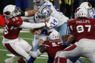 Arizona Cardinals' Reggie Walker (56), Haason Reddick (43) and Jordan Phillips (97) combine to sack Dallas Cowboys' Andy Dalton (14) in the second half of an NFL football game in Arlington, Texas, Monday, Oct. 19, 2020. (AP Photo/Michael Ainsworth)