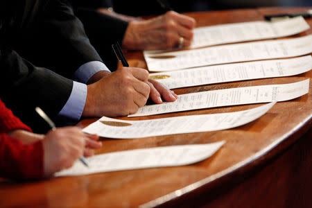 North Carolina Electoral College representatives sign the Certificates of Vote after they all cast their ballots for U.S. President-elect Donald Trump in the State Capitol building in Raleigh, North Carolina, U.S., December 19, 2016. REUTERS/Jonathan Drake