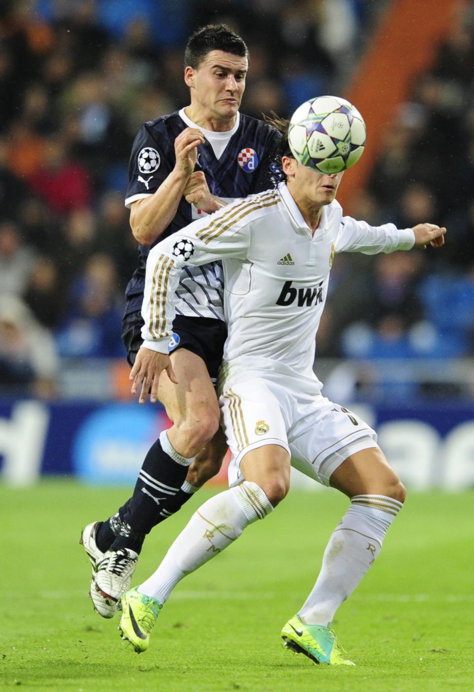 Real Madrid's German midfielder Mesut Ozil (R) vies with Dinamo Zagreb's Bosnian midfielder Mehmed Alispahic (L) during the Champions League group D football match between Real Madrid and Dinamo Zagreb at the Santiago Bernabeu stadium in Madrid on November 22, 2011. AFP PHOTO/JAVIER SORIANO (Photo credit should read JAVIER SORIANO/AFP/Getty Images)