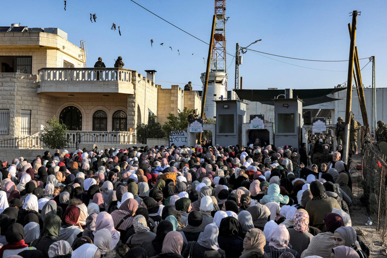 Palestinians queue at an Israeli checkpoint in Bethlehem (Hazem Bader / AFP via Getty Images)
