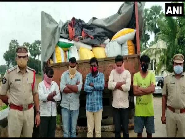 Police personnel with the truck loaded with the PDS rice, along with the accused. [Photo/ANI]