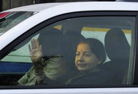 J. Jayalalithaa, former chief minister of Tamil Nadu state, waves to her supporters from a car after leaving the jail in the southern Indian city of Bangalore October 18, 2014. India's top court on Friday granted bail to a powerful regional politician, imprisoned for amassing millions of rupees in illegal wealth, after her lawyer said she was in poor health. Jayalalithaa was sentenced to four years in jail last month for holding 530 million rupees ($8.7 million) in unaccounted cash and property. REUTERS/Abhishek N. Chinnappa (INDIA - Tags: POLITICS)