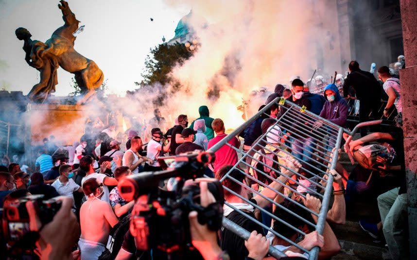 Protesters clash with police outside the Serbian National Assembly in Belgrade