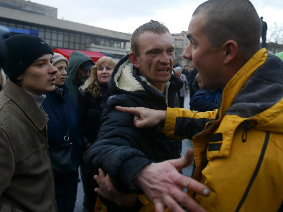 In this photo taken Wednesday, March 5, 2014, local residents discuss the situation at a central square in Simferopol, Ukraine. Ukraine is facing a potentially crippling geographic and cultural divide, a growing gulf between supporters of Russia who dominate the east and south of the country, and western Ukrainians who yearn for closer ties to Western Europe. One side of that divide is even starker in Crimea, a Black Sea peninsula. For much of the past 200 years, Crimea was under Russian and Soviet control, and today most Crimeans see themselves as only nominally Ukrainian and Russian is, by far, the dominant language (AP Photo/Sergei Grits)