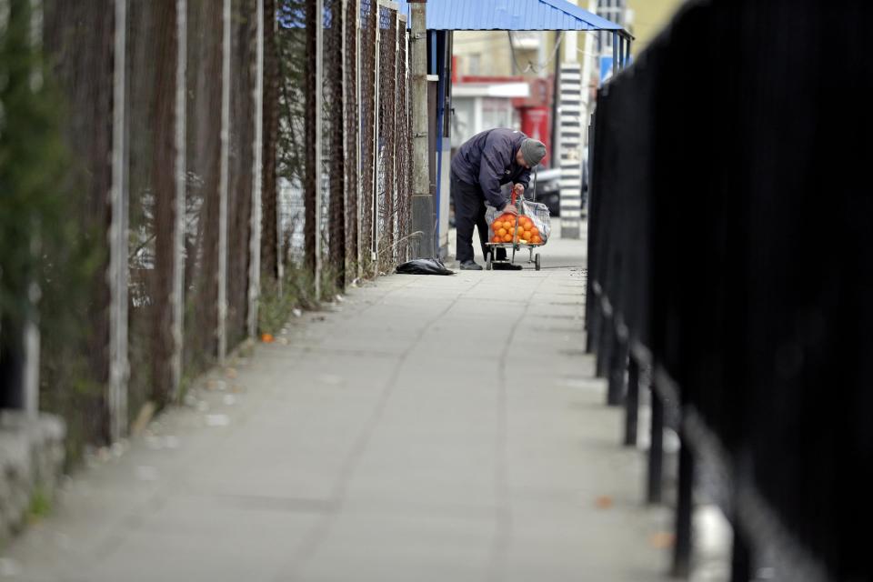 A man looks over his cart full of tangerines at the Abkhazian border Wednesday, Feb. 5, 2014, near Sochi, Russia. Abkhazia is a festering geopolitical sore, and the economic system still operating in these and many other parts of Russia is decidedly 19th century. As Russia opens its doors to a curious world with the Sochi Games, places like this border expose the vast contradictions still gripping the one-time superpower 21 years after the Soviet Union collapsed. (AP Photo/Morry Gash)