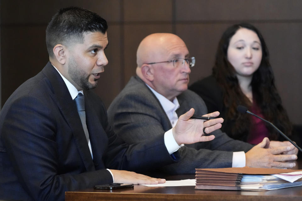 Robert E. Crimo Jr., center, and attorney Alanna Myerson, right, listen to attorney George Gomez during an appearance before Judge George D. Strickland at the Lake County Courthouse, Friday, July 14, 2023, in Waukegan, Ill. Judge George Strickland on Friday set a Nov. 6 trial date for Crimo Jr. who is charged with helping his son obtain a gun license three years before the son allegedly shot dead seven people at a Fourth of July parade in suburban Chicago last year. (AP Photo/Nam Y. Huh, Pool)