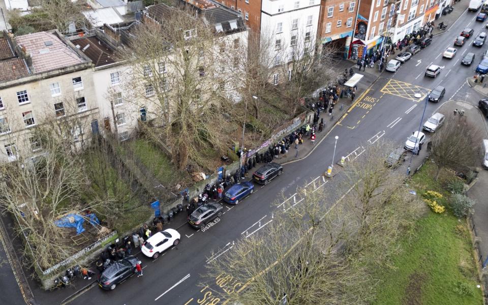 Hundreds of people wait in line on Tuesday morning