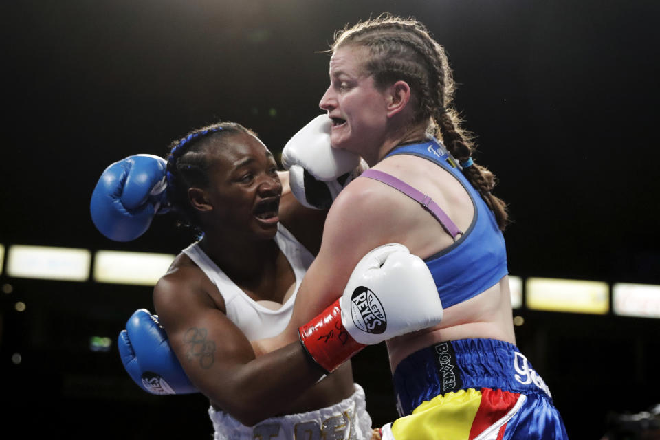 Claressa Shields, left, hits Belgium's Femke Hermans during their WBC/IBF/WBA middleweight title boxing match, Saturday, Dec. 8, 2018, in Carson, Calif. (AP Photo/Chris Carlson)