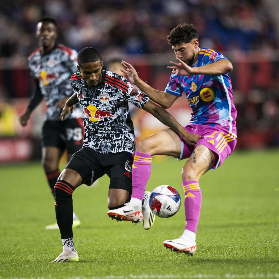 Toronto FC midfielder Jonathan Osorio, right, vies for the ball against New York Red Bulls defender Kyle Duncan during an MLS soccer match Saturday, Oct. 7, 2023, in Harrison, N.J. (AP Photo/Eduardo Munoz Alvarez)