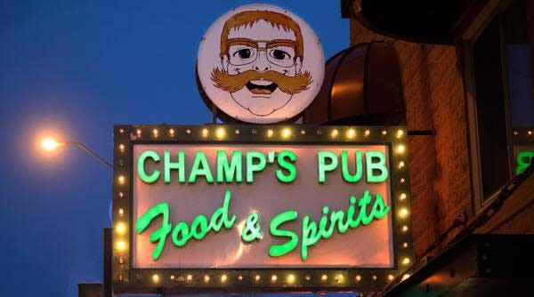 Champ's Pub's sign, featuring a likeness of founder Dave "Champ" Beauchamp and his iconic handlebar moustache, will stay after Beauchamp sold the pub to a new owner.