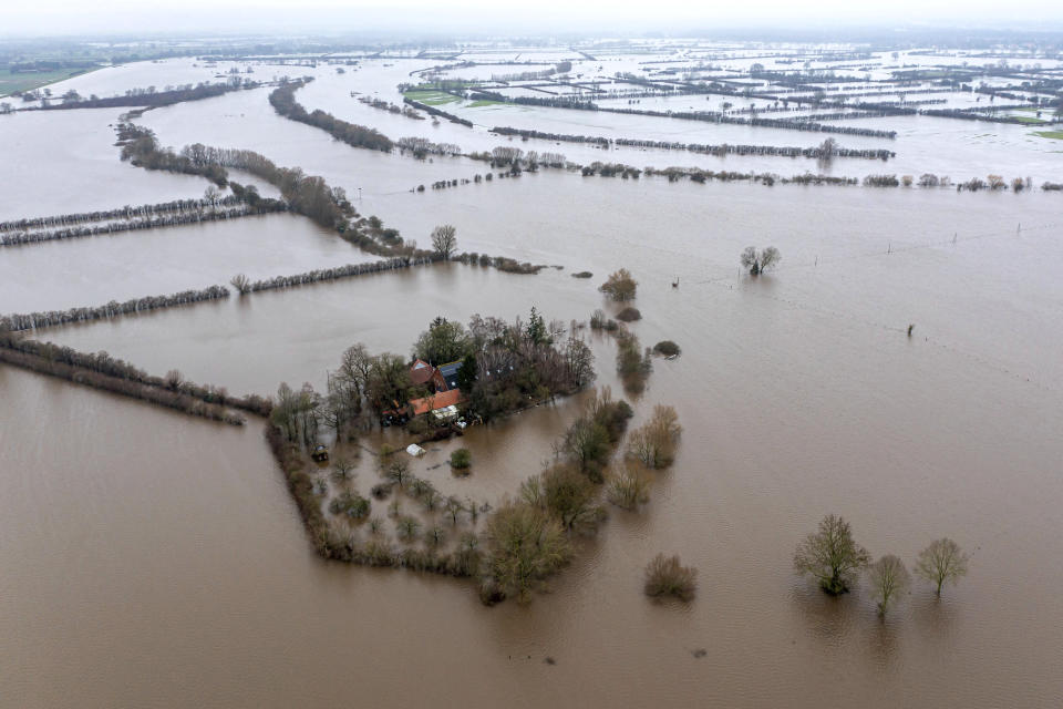 A farm is seen flooded by the Weser river in Thedinghausen, Germany, Friday, Jan. 5, 2024. (Sina Schuldt/dpa via AP)