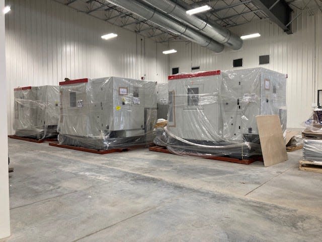 New machines waiting to be set up on the new machine shop floor.