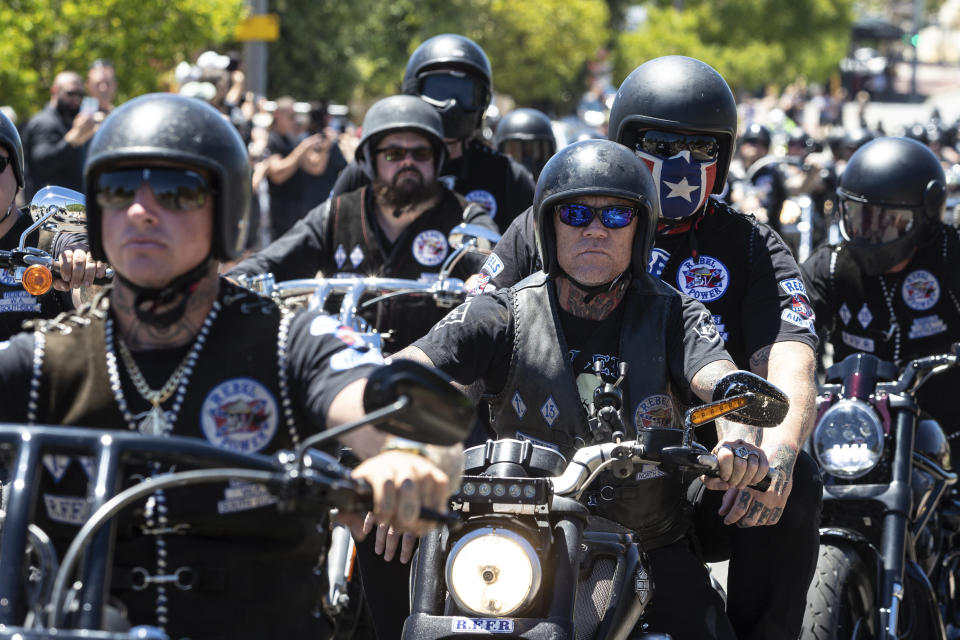 A motorcade follows the coffin of Rebels biker Nick Martin into Pinnaroo Cemetery in Perth, Australia, on Wednesday, Dec. 23, 2020. The former Rebels president was gunned down earlier in the month at the Perth Motorplex. Martin’s murder left police a trove of evidence that led them to the culprit. But they wanted more. The coronavirus pandemic provided it in the form of an electronic dragnet: QR code check-in data from contact tracing apps of 2,439 fans who attended the December 2020 race. (Richard Wainwright/AAP via AP)