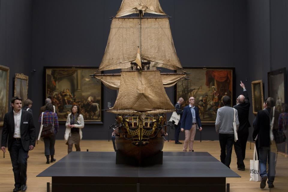 Visitors admire a 1698 model of the late 17th century Dutch warship William Rex during a press preview of the renovated Rijkmuseum in Amsterdam, Thursday, April 4, 2013. The Rijksmusuem, home of Rembrandt's Night Watch and other national treasures, is preparing to reopen its doors on April 13, 2013 after a decade-long renovation. (AP Photo/Peter Dejong)