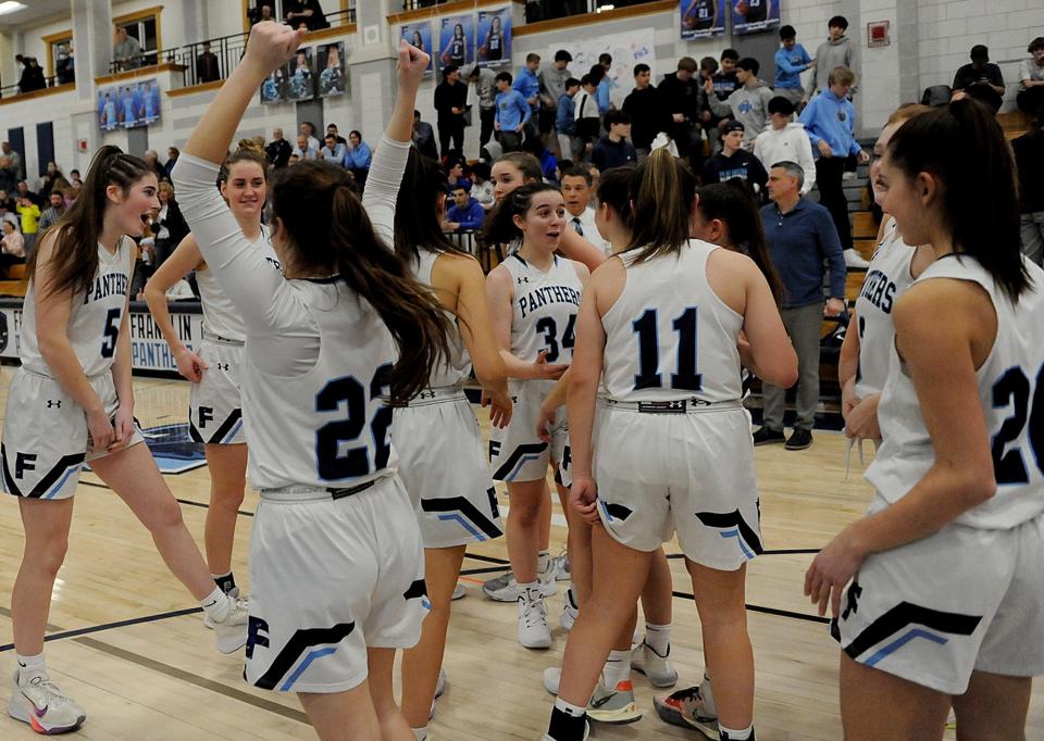 The Franklin High School girls basketball team hosted Braintree High School in a Round of 32 playoff game Friday night, March 4, 2022. Franklin won, 70-43.  Pictured, players celebrate after ther win.  From left: senior Brigid Earley (#5), senior Julia White (#22), freshman Elle Bonacci (#34), Bridget Leo (#11), and freshman Chloe Fales (#20).