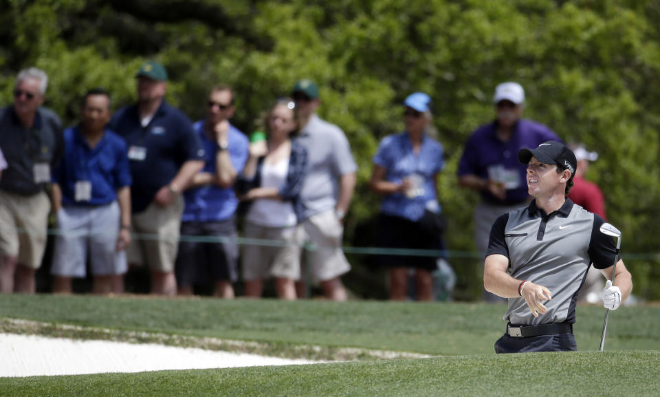 Rory McIlroy, of Northern Ireland, watches his shot out of a bunker on the first hole during the second round of the Masters golf tournament Friday, April 11, 2014, in Augusta, Ga. (AP Photo/Darron Cummings)