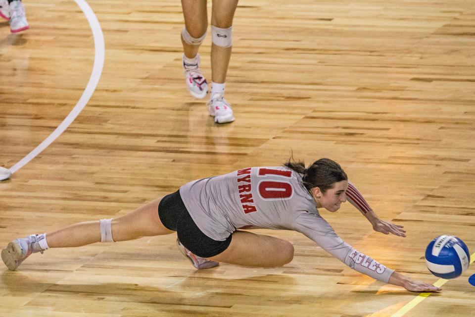 Smyrna senior Anna Richardson (10) dives for the save against Ursuline Academy during the DIAA Girls Volleyball Tournament championship game at the Bob Carpenter Center in Newark, Thursday, Nov. 16, 2023. Smyrna won 25-14.