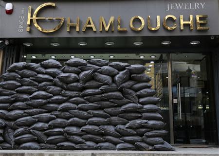 Sandbags are piled up in front of Hassan Ghamlouche's jewellery shop at a stronghold of Shi'ite group Hezbollah in the southern suburbs of the Lebanese capital Beirut January 30, 2014. REUTERS/Jamal Saidi