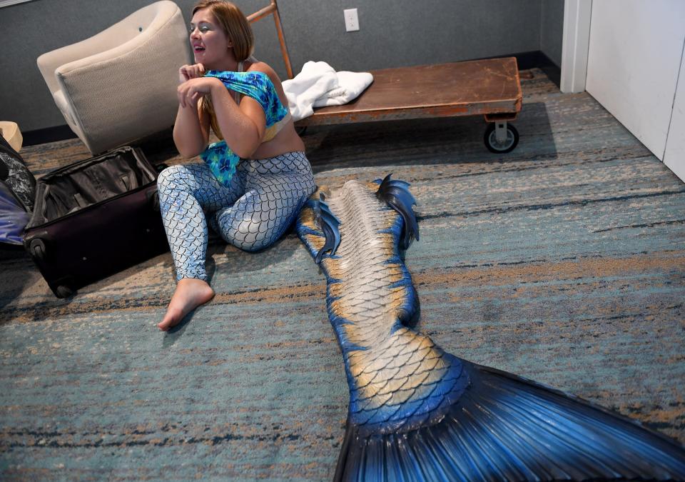 Tasha Haight, owner and head mermaid of Mermaid Tasha LLC, prepares to go swim July 11, 2023, at Fenwick Shores in Fenwick Island, Delaware.