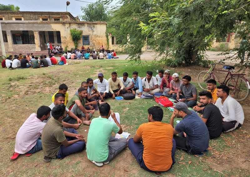 Government job aspirants take part in a quiz as they prepare for various jobs in a college ground in Arrah