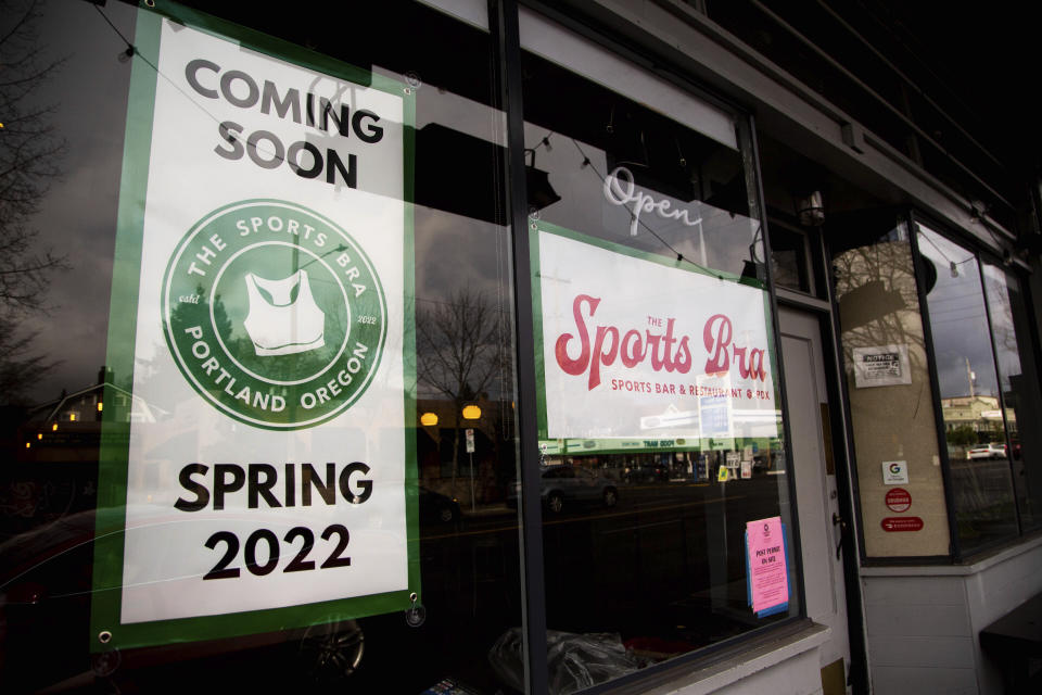 Banners previewing the opening of The Sports Bra, a bar and restaurant dedicated to women's sports, hang in the window at 2512 NE Broadway in Portland on Monday, Feb. 22, 2022. (Vickie Connor/The Oregonian via AP)