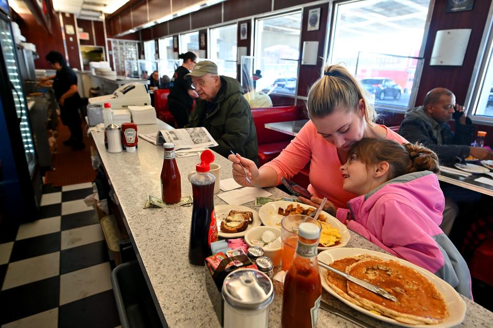 Jenny Martin of Boston and her daughter, Gabby Aiello, enjoy lunch and looking at videos on a phone at Kenmore Diner last December.