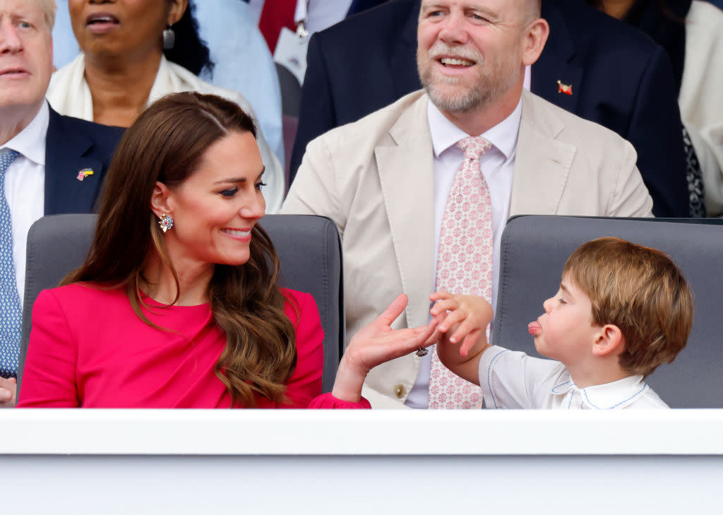 The Duchess of Cambridge smiles while Prince Louis pokes his tongue out. (Getty Images)