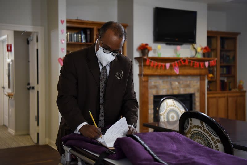 The Wider Image: 'I just ask God to help me': Texas funeral home crushed by death as U.S. COVID toll nears 500,000