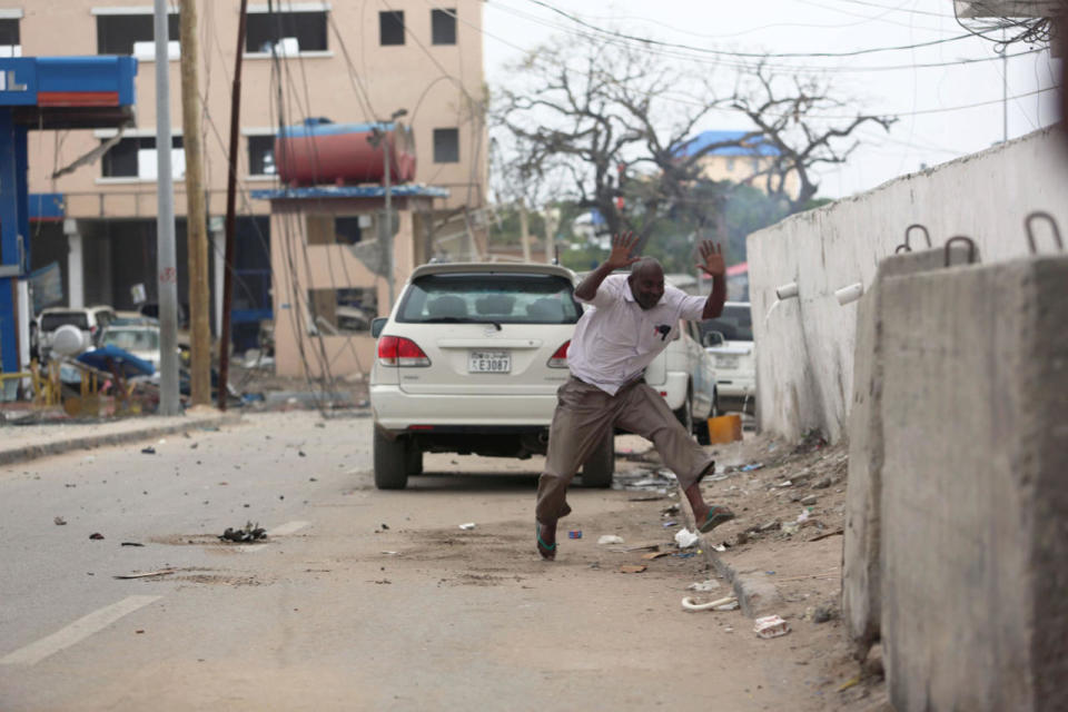 Man runs from the scene of a suicide bombing