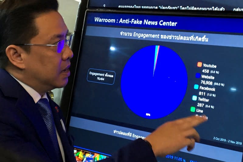 Puttipong Punnakanta, Thailand's Digital Minister looks at a screen at the Anti-Fake News in Bangkok