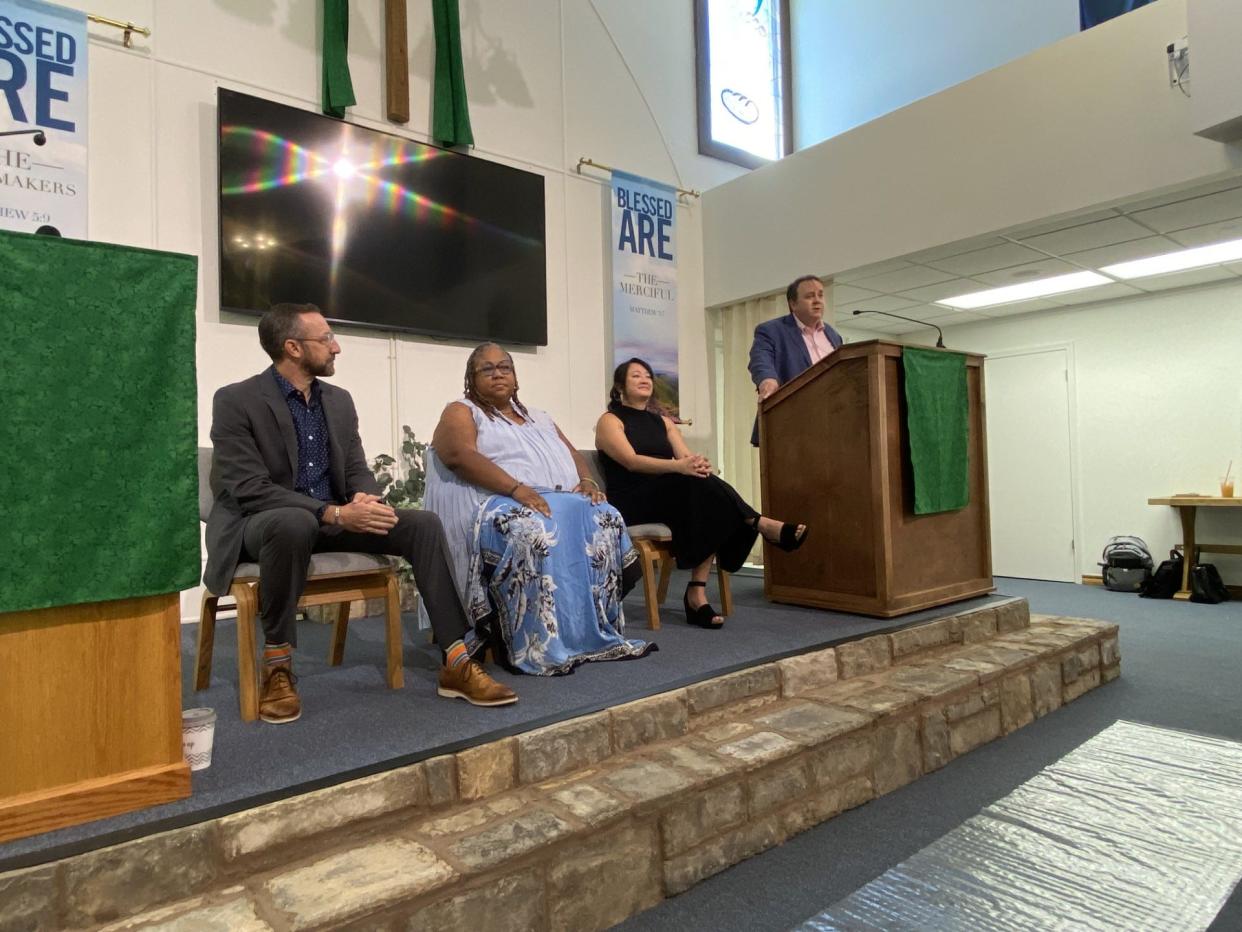 The Rev. Don Heath, far right, speaks before a panel discussion begins on Saturday, the second day of a forum entitled "The Threat of White Christian Nationalism" held at Edmond Trinity Christian Church (Disciples of Christ). The panel, from left, includes: Adam Brooks, Sheri Dickerson and Veronica Laizure. [Carla Hinton]